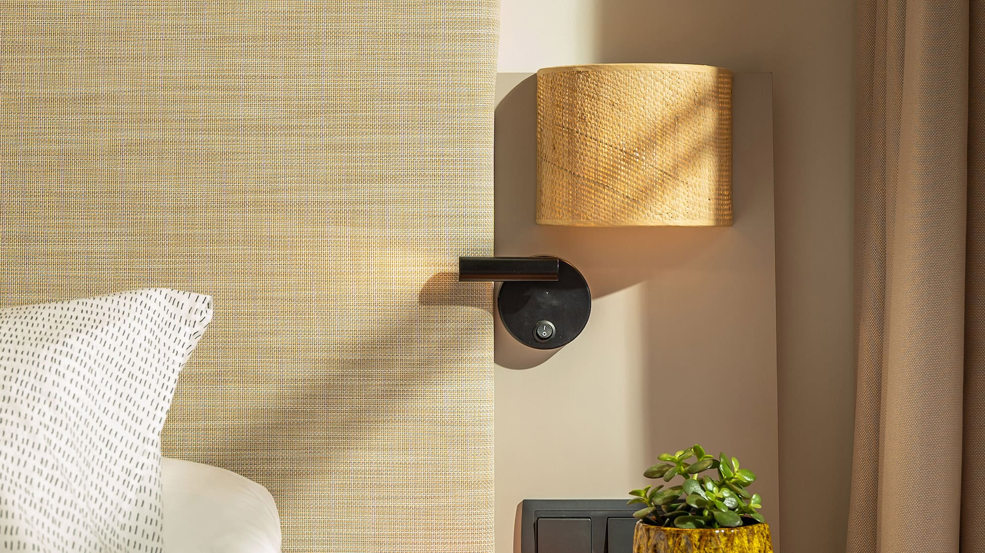 a bed with a plant on a table