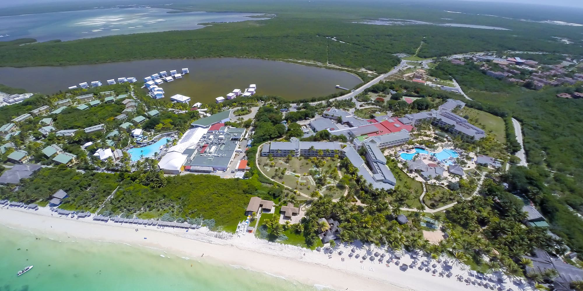 a aerial view of a beach with buildings and a body of water