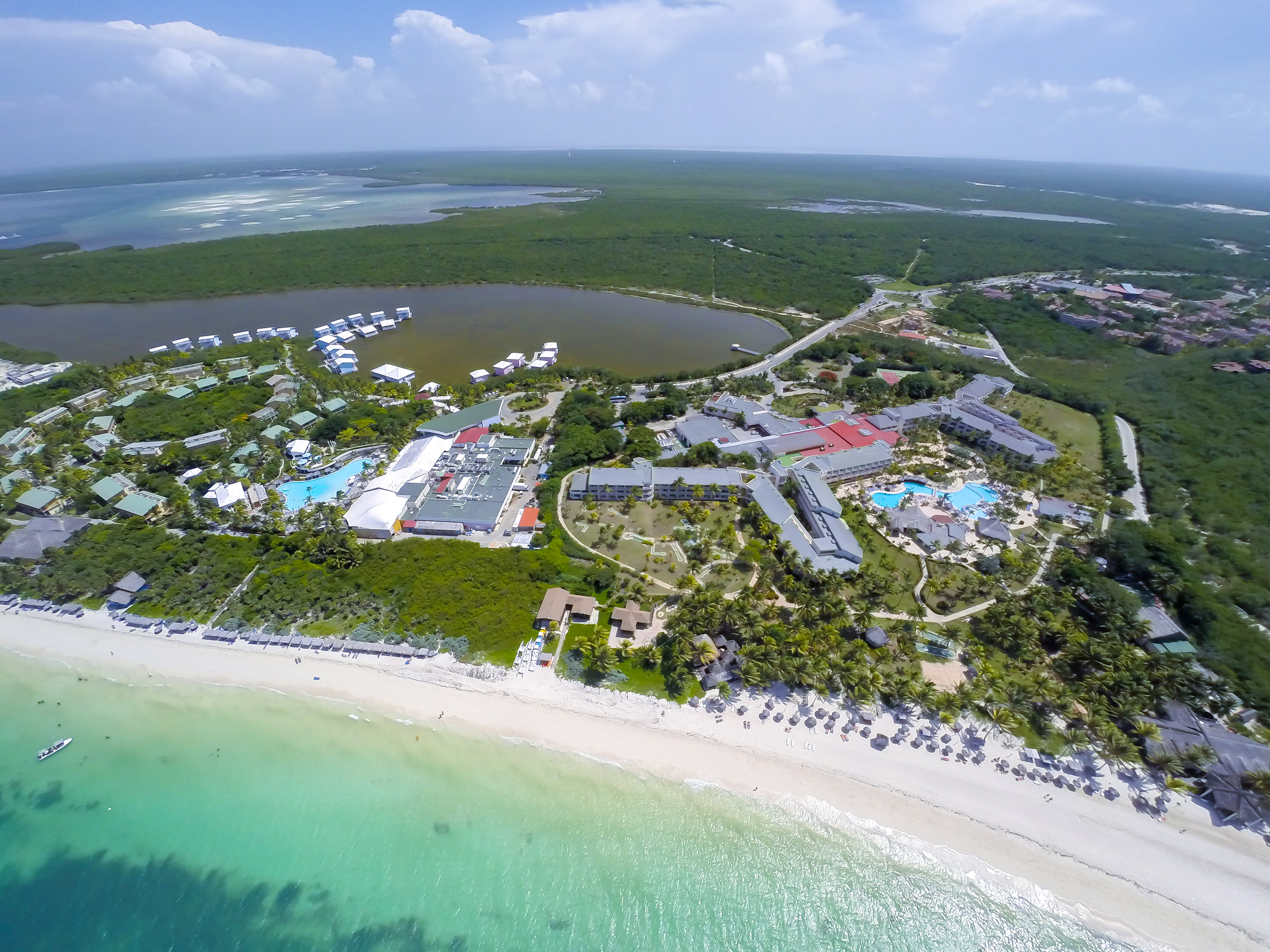 a aerial view of a beach with buildings and a body of water