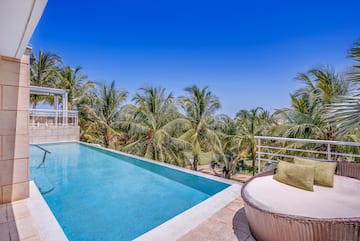 a pool with a deck and palm trees