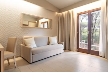 a couch in a room with a door and a mirror