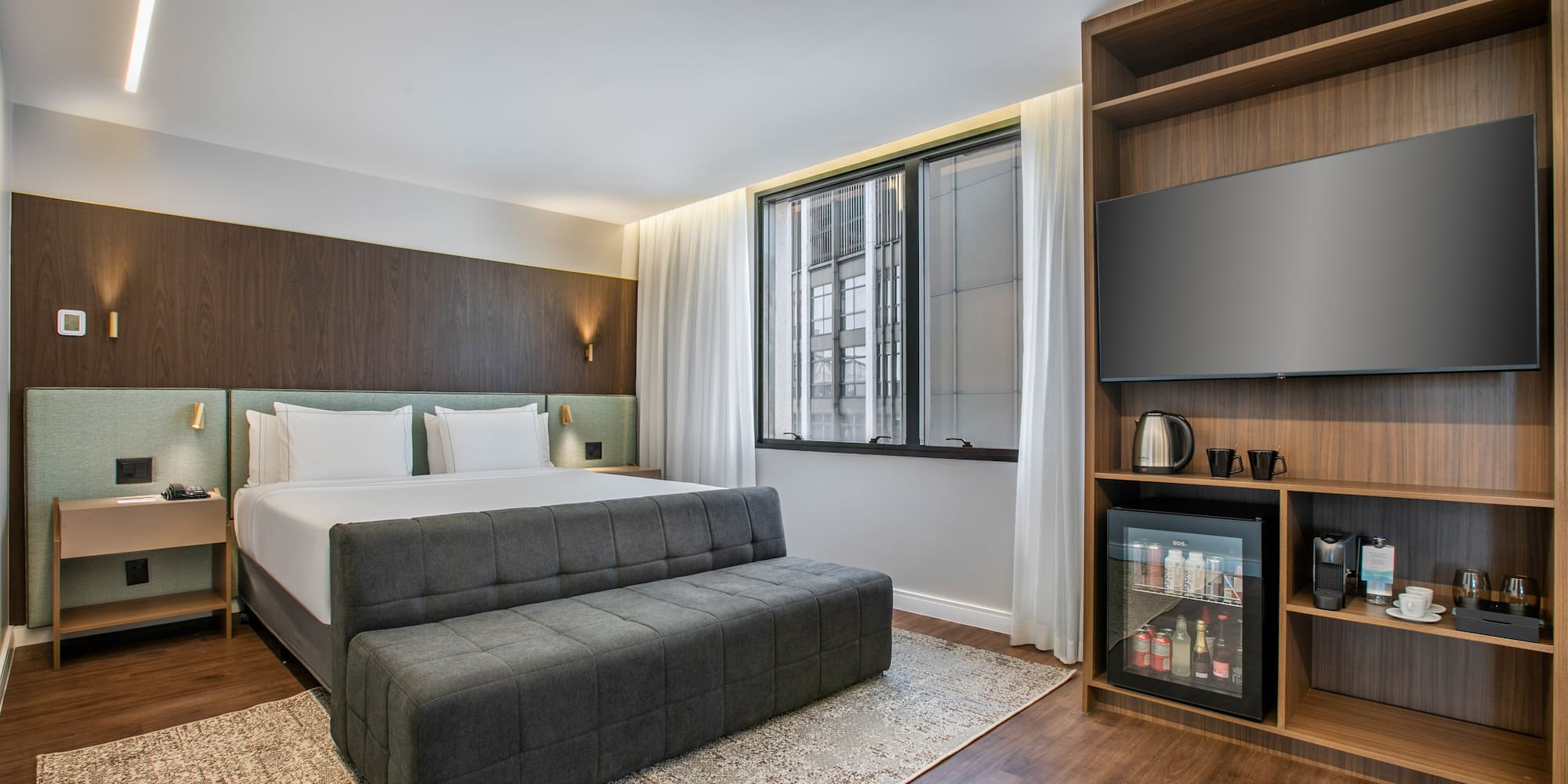 a room with a bed and a tv