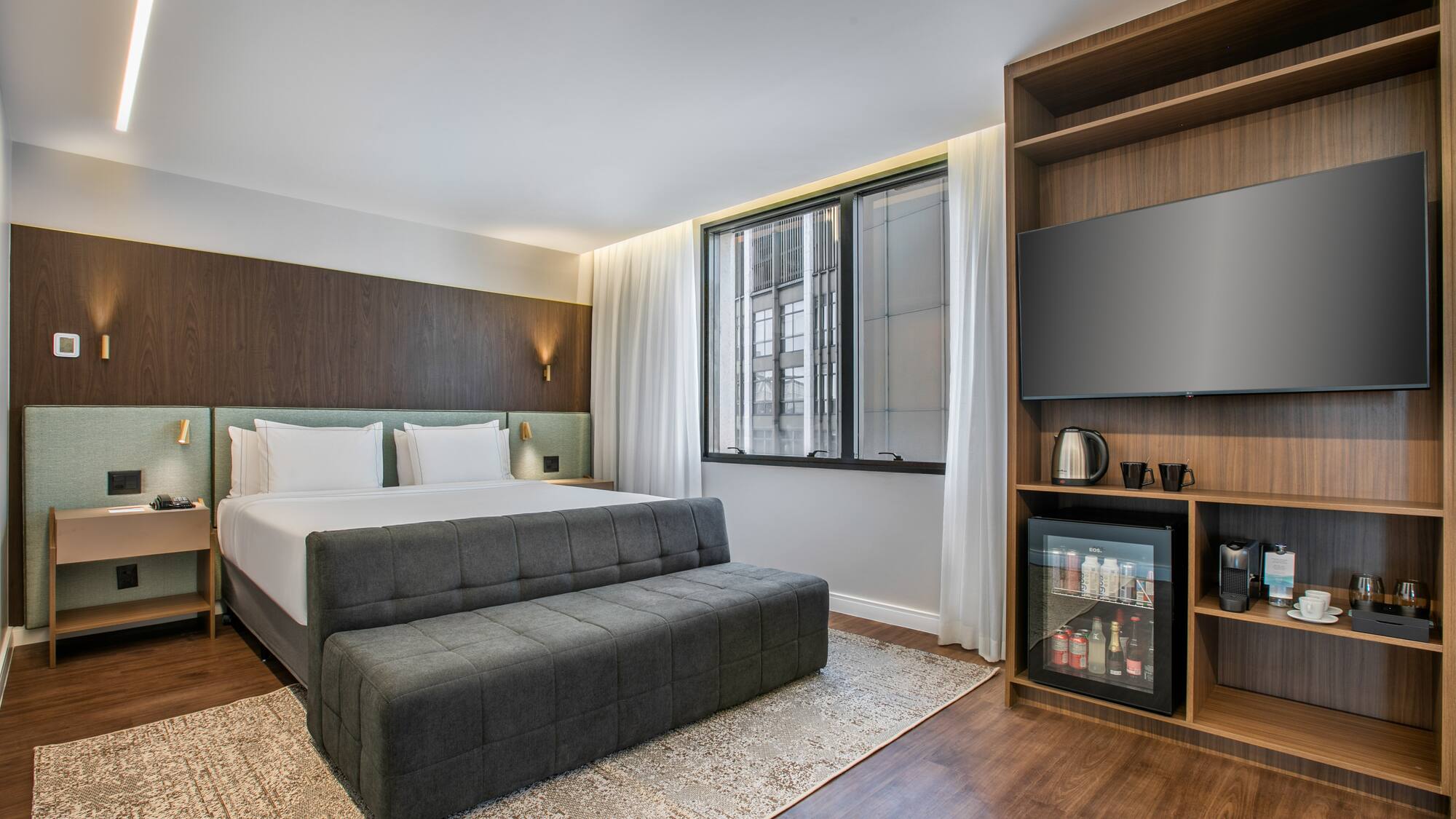 a room with a bed and a tv