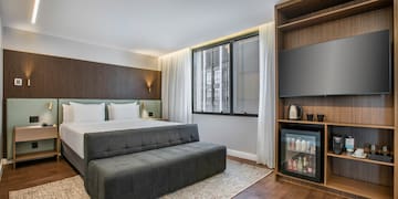 a room with a bed and a tv