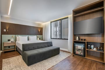 a room with a bed and a tv