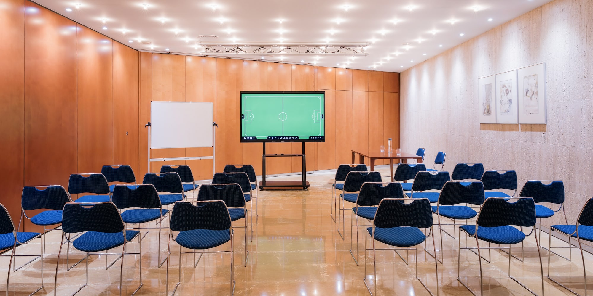 a room with chairs and a screen