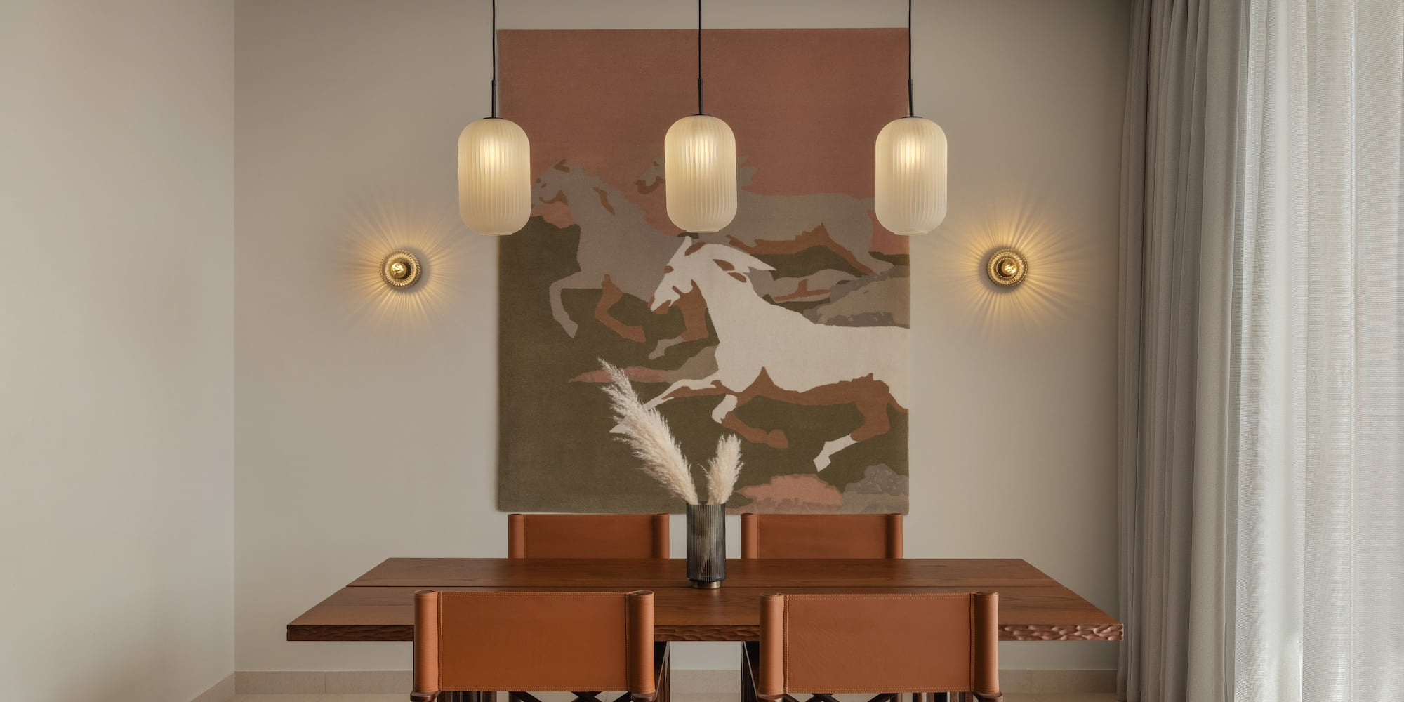 a dining table with chairs and art from ceiling