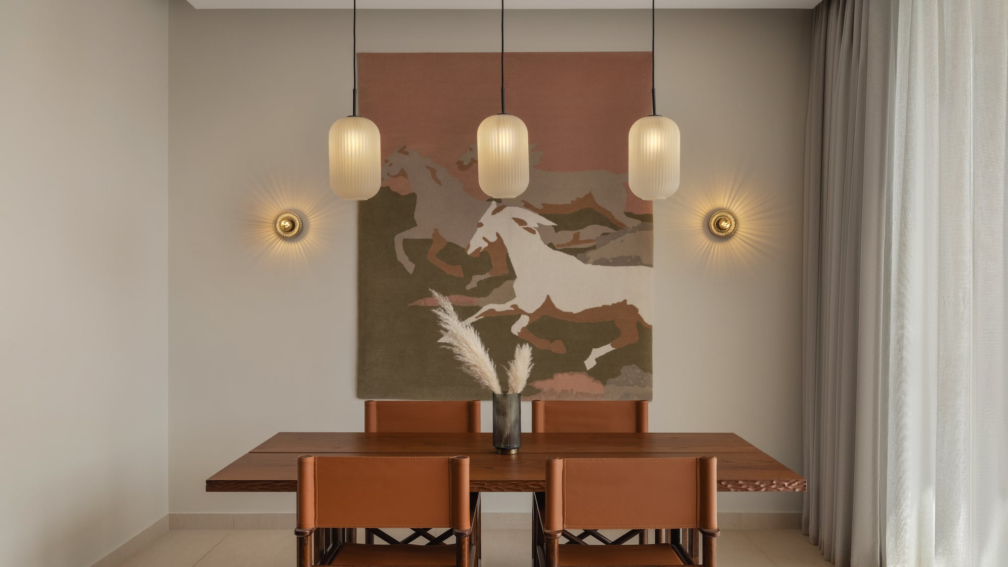 a dining table with chairs and art from ceiling