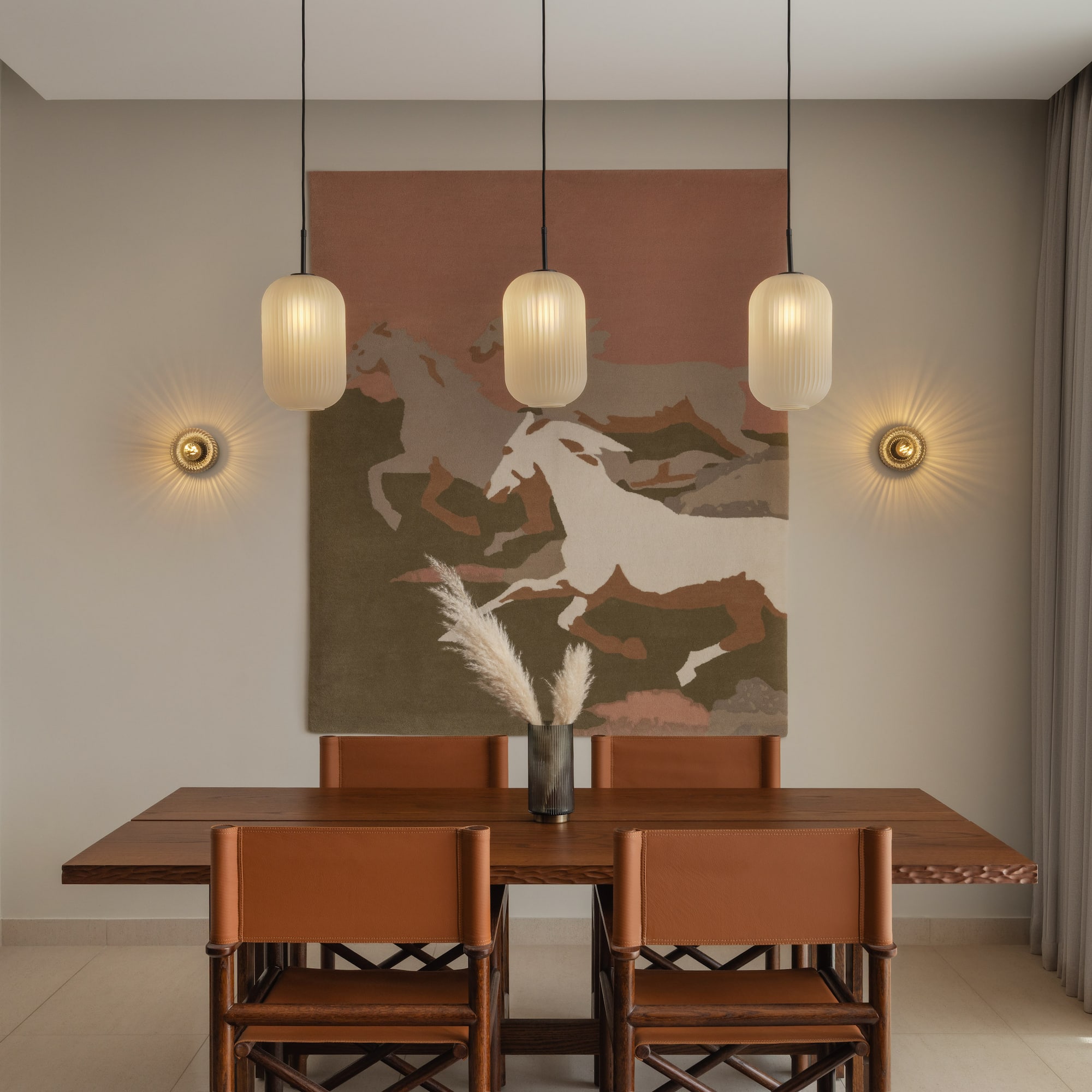 a dining table with chairs and art from ceiling