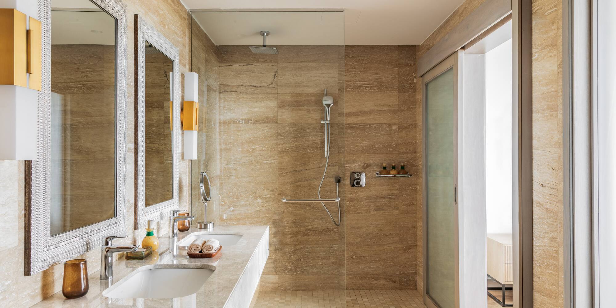 a bathroom with marble walls and a shower