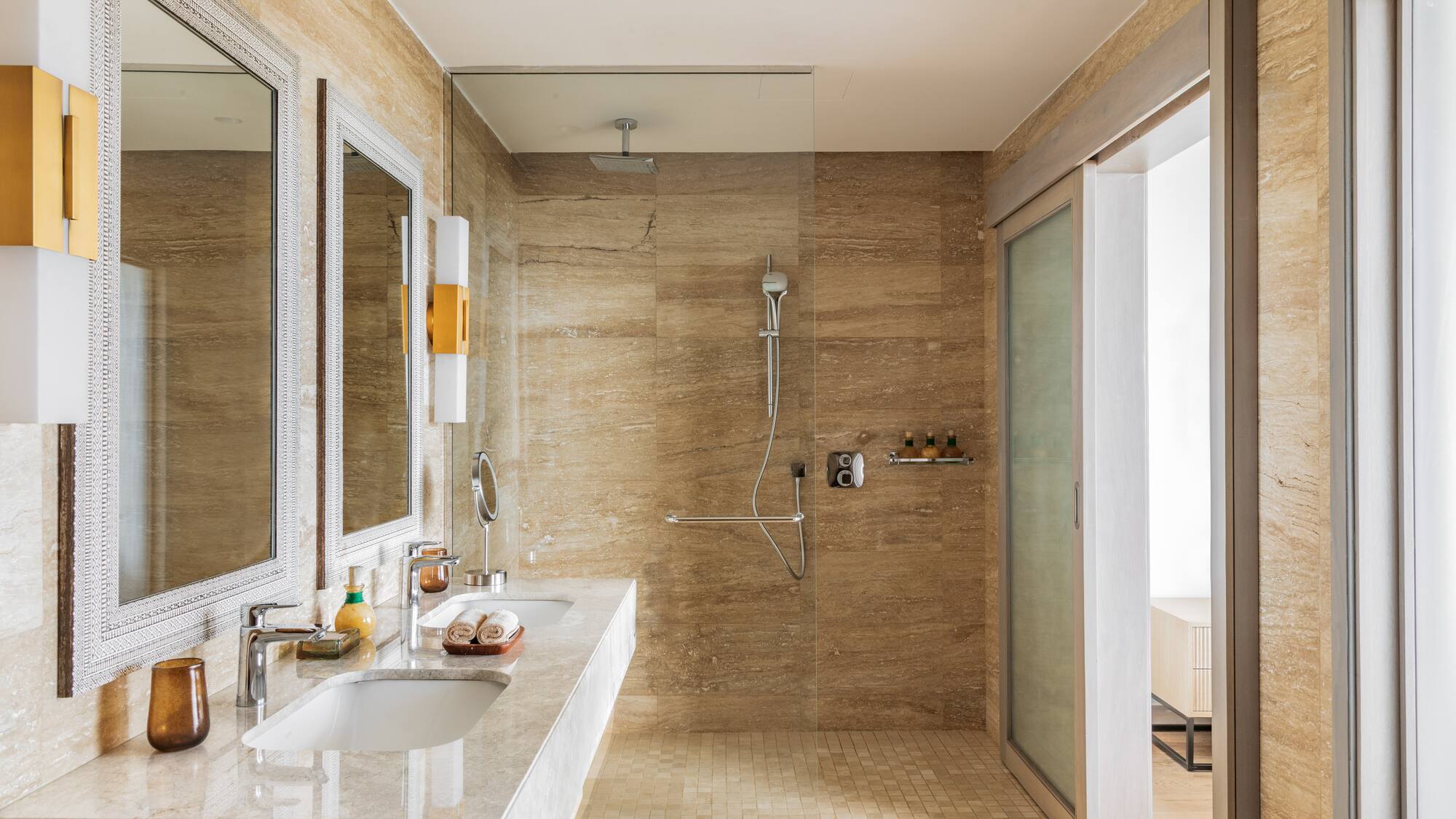 a bathroom with marble walls and a shower