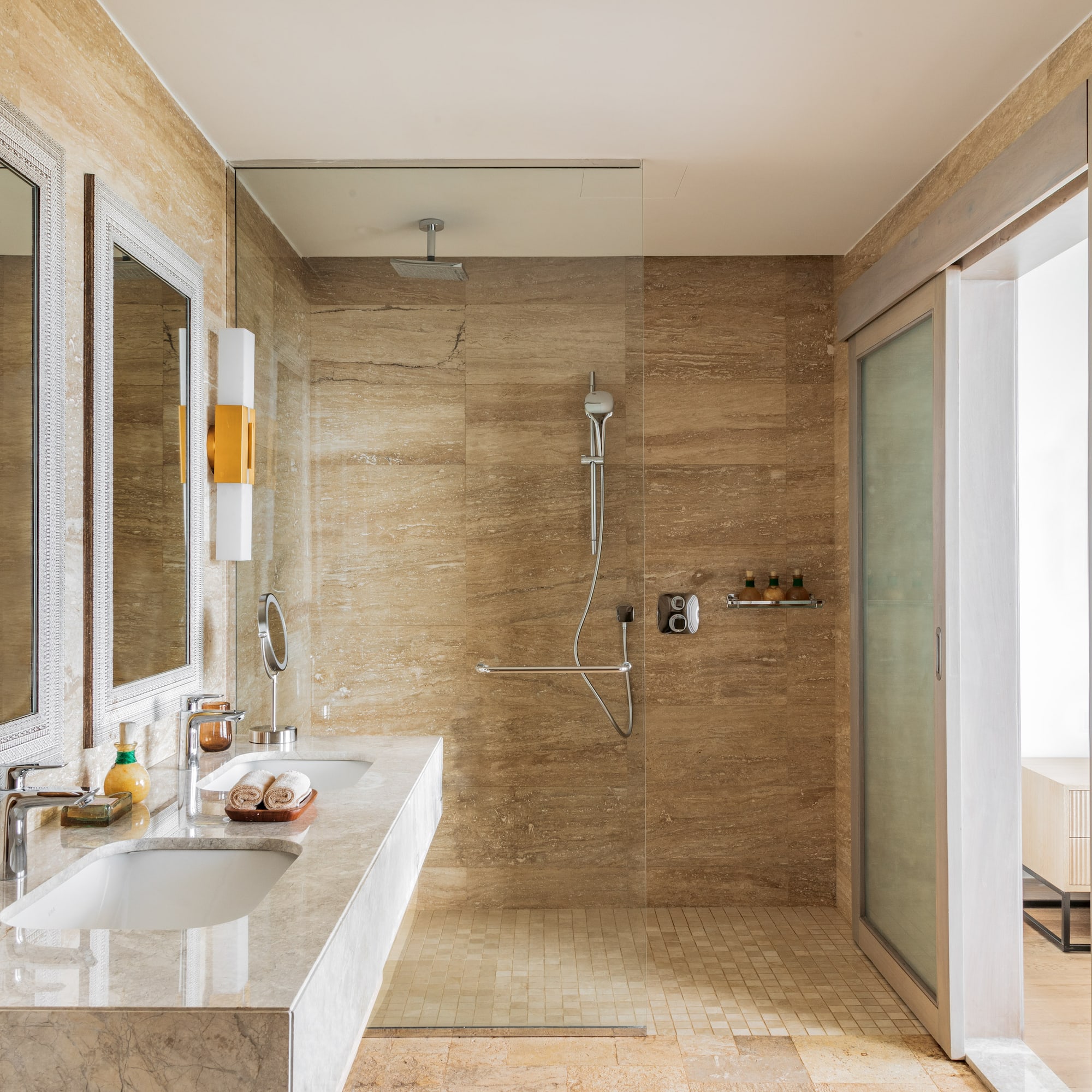 a bathroom with marble walls and a shower