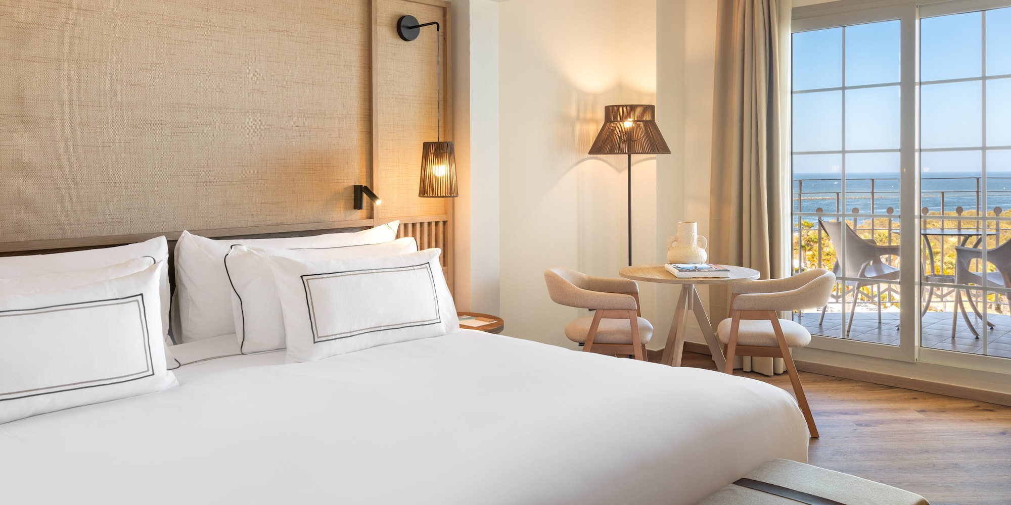 a room with a bed and a table and chairs