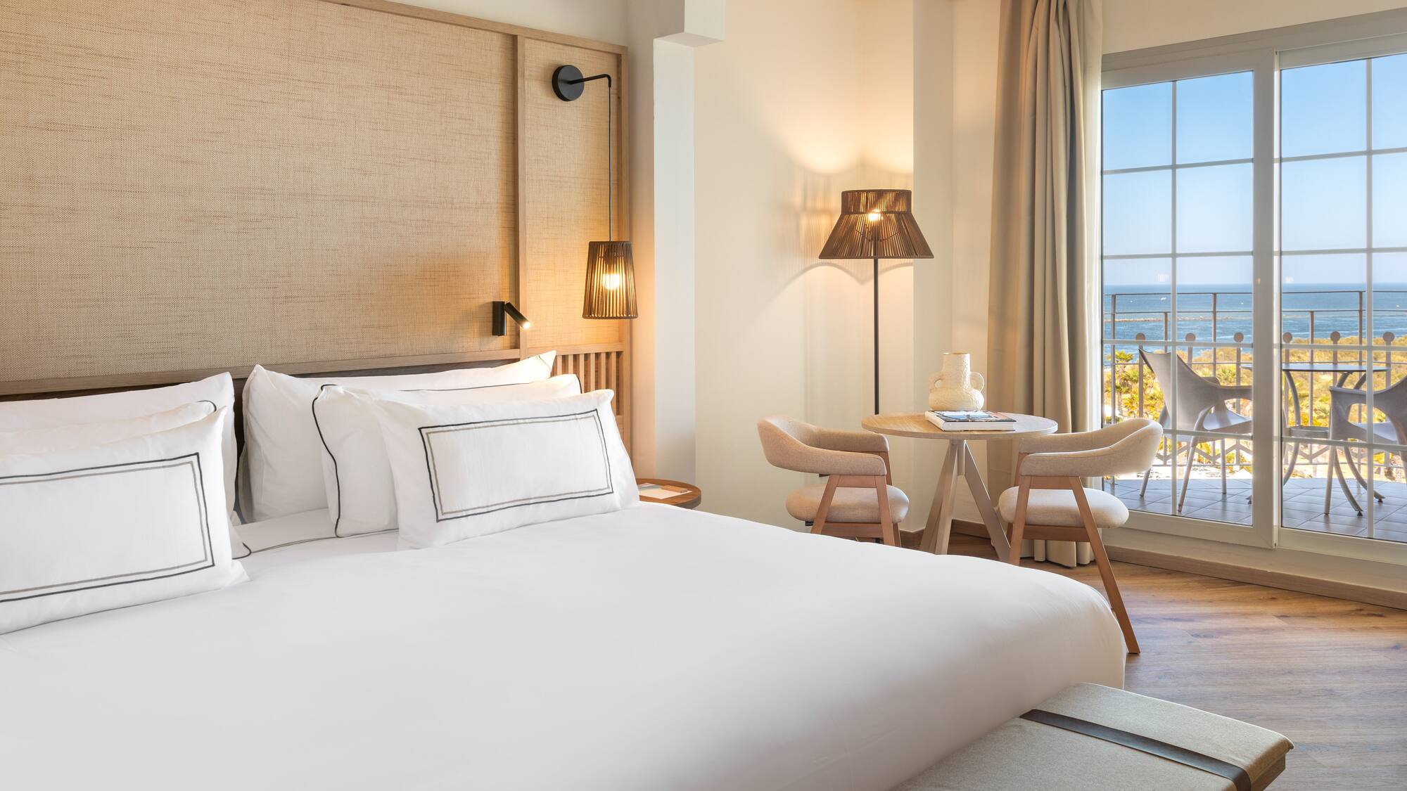 a room with a bed and a table and chairs