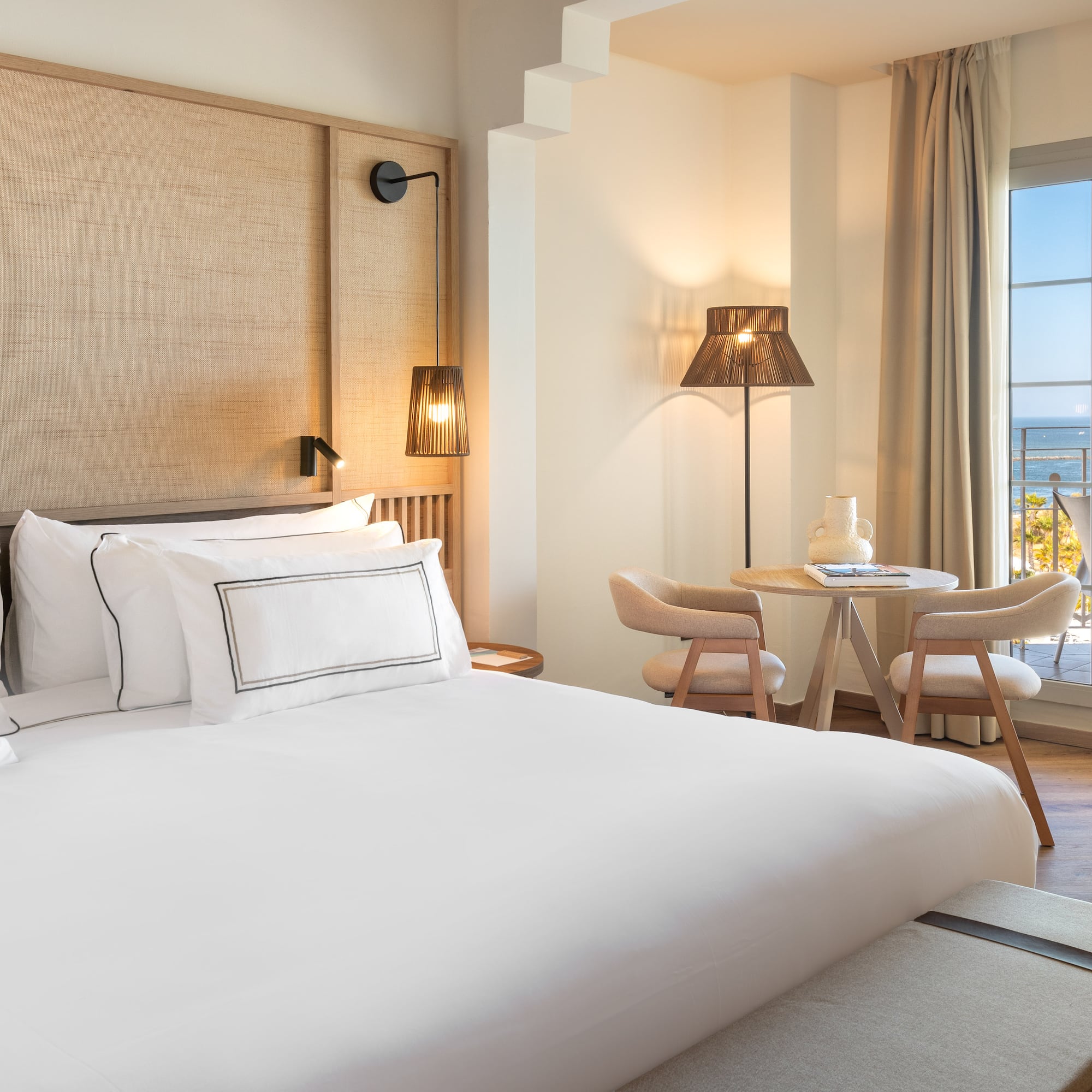 a room with a bed and a table and chairs