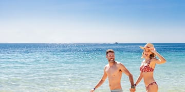 a man and woman in a garment on a beach