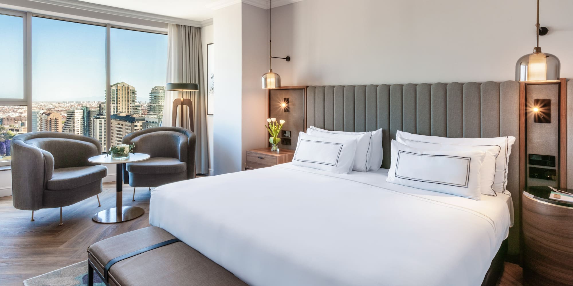 a hotel room with a large bed and a table