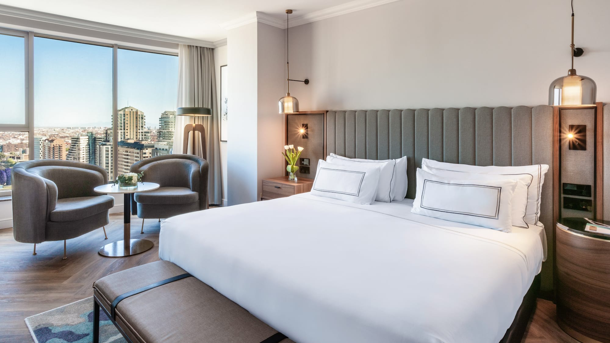 a hotel room with a large bed and a table