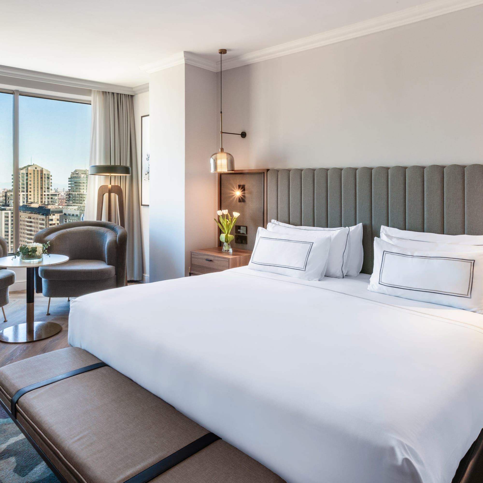 a hotel room with a large bed and a table