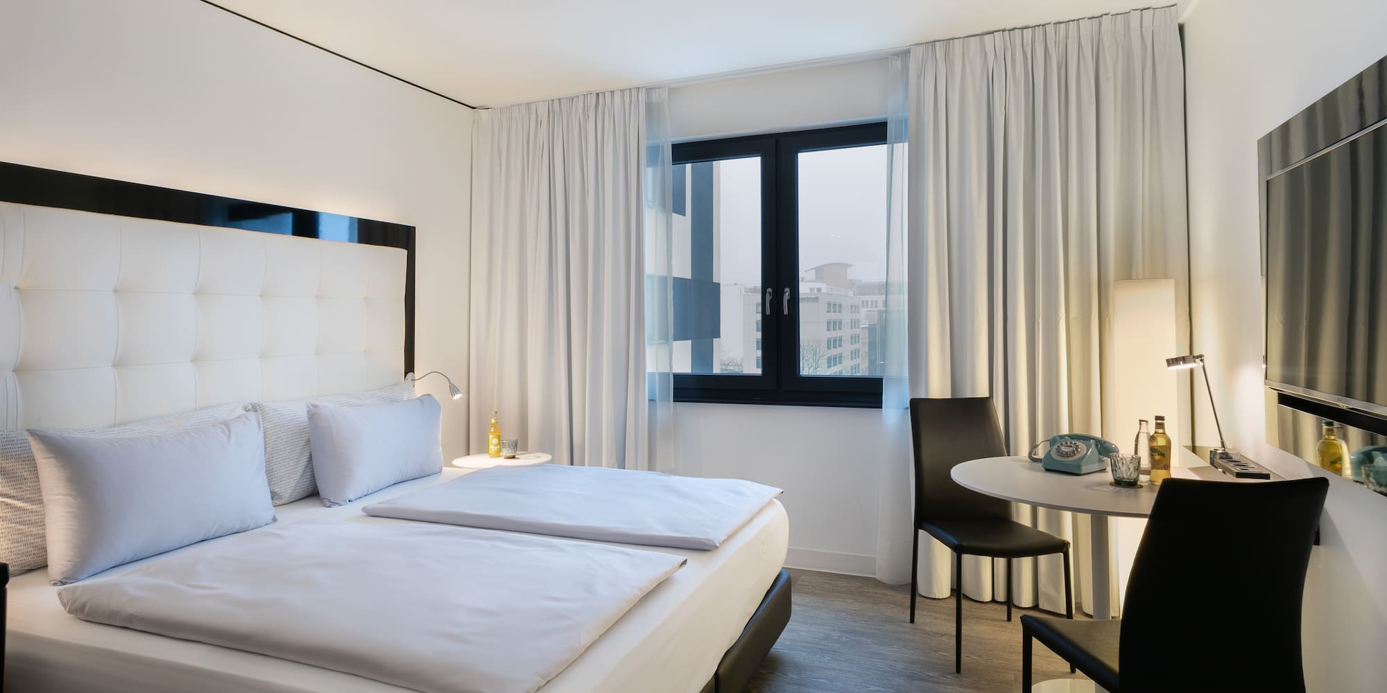 a bedroom with a table and chairs