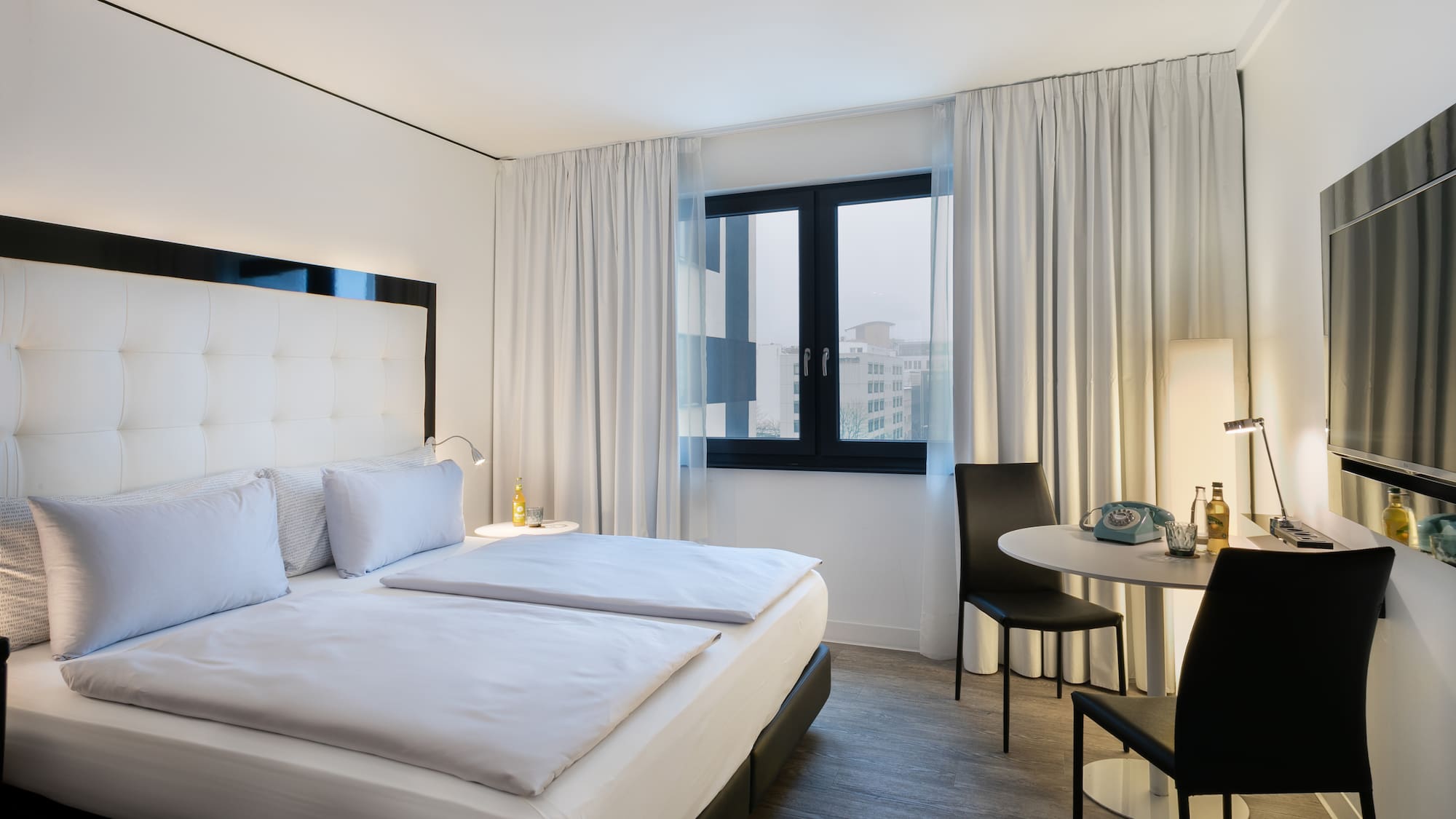 a bedroom with a table and chairs