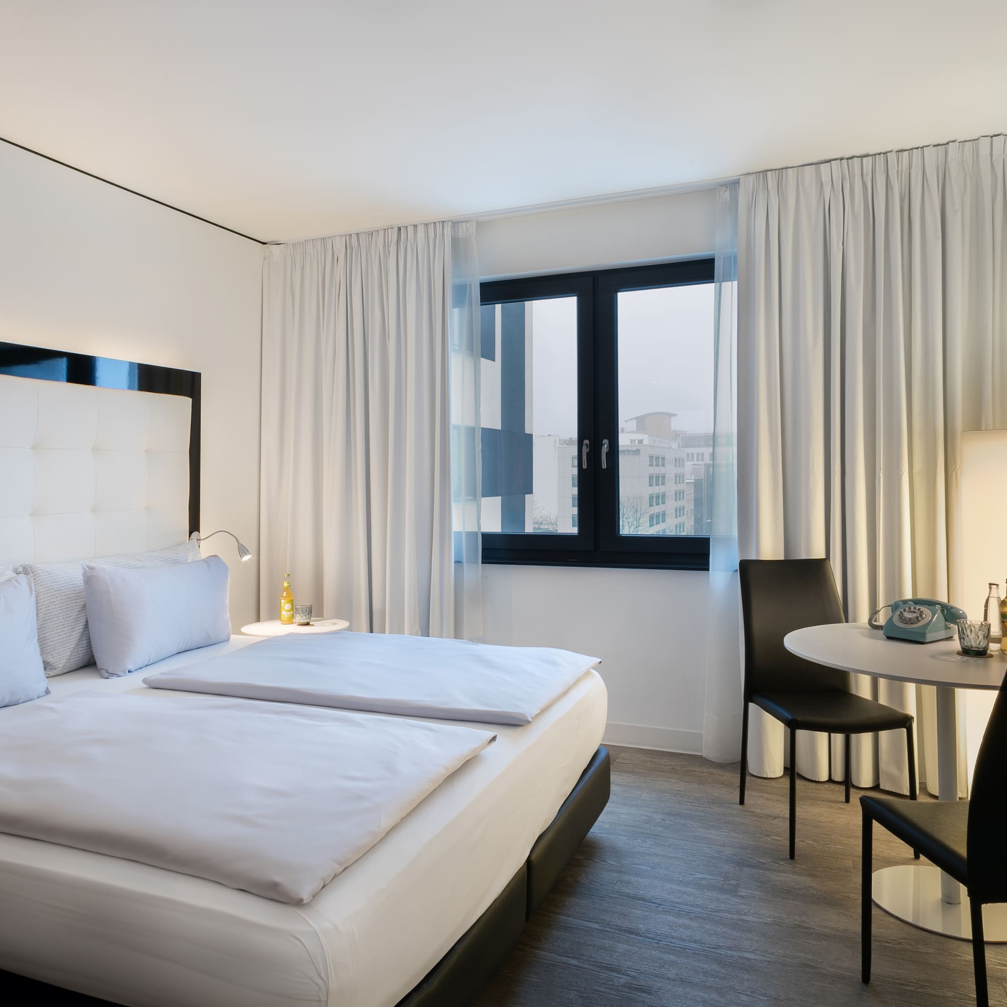 a bedroom with a table and chairs