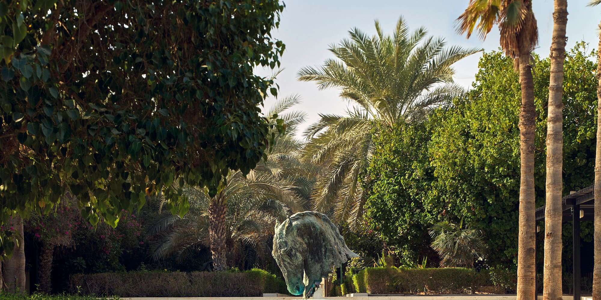 a fountain with a water fountain and trees