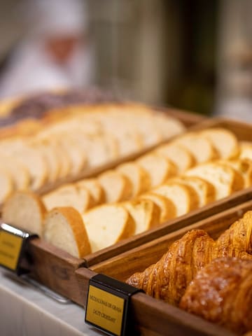 a tray of bread and croissants