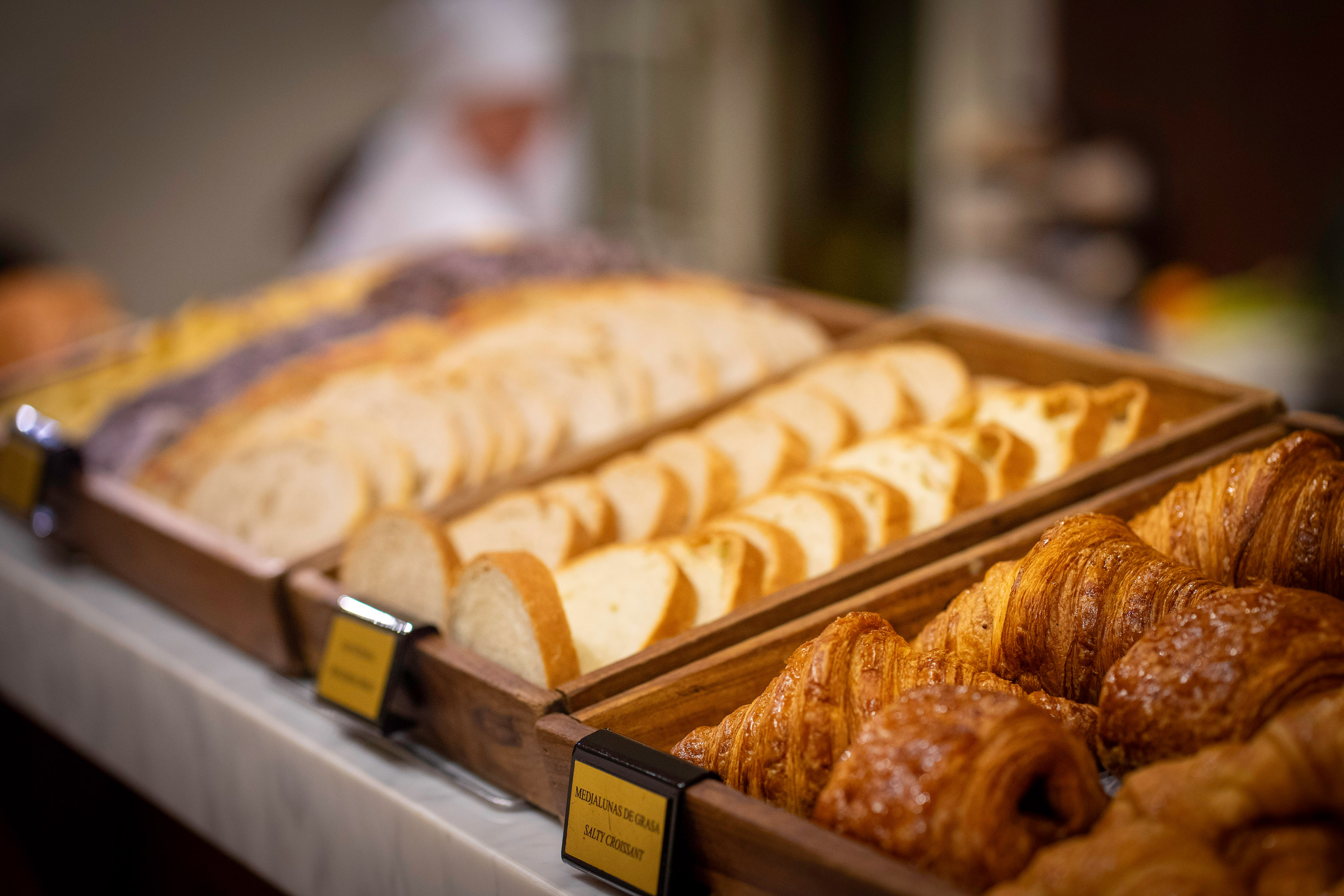 a tray of bread and croissants