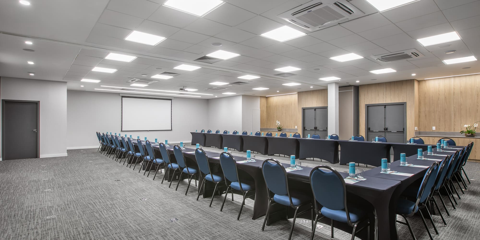 a room with long tables and chairs