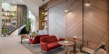 a room with a couch and chairs