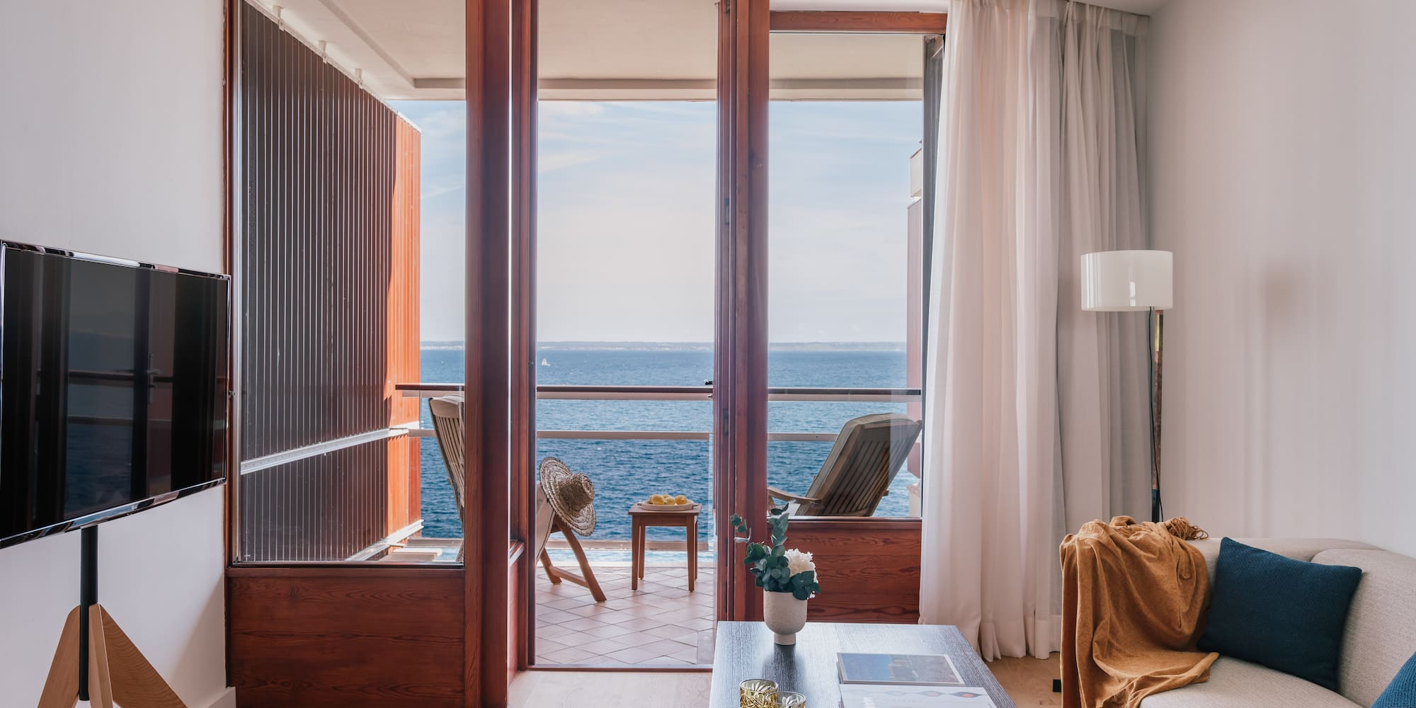 a living room with a view of the ocean