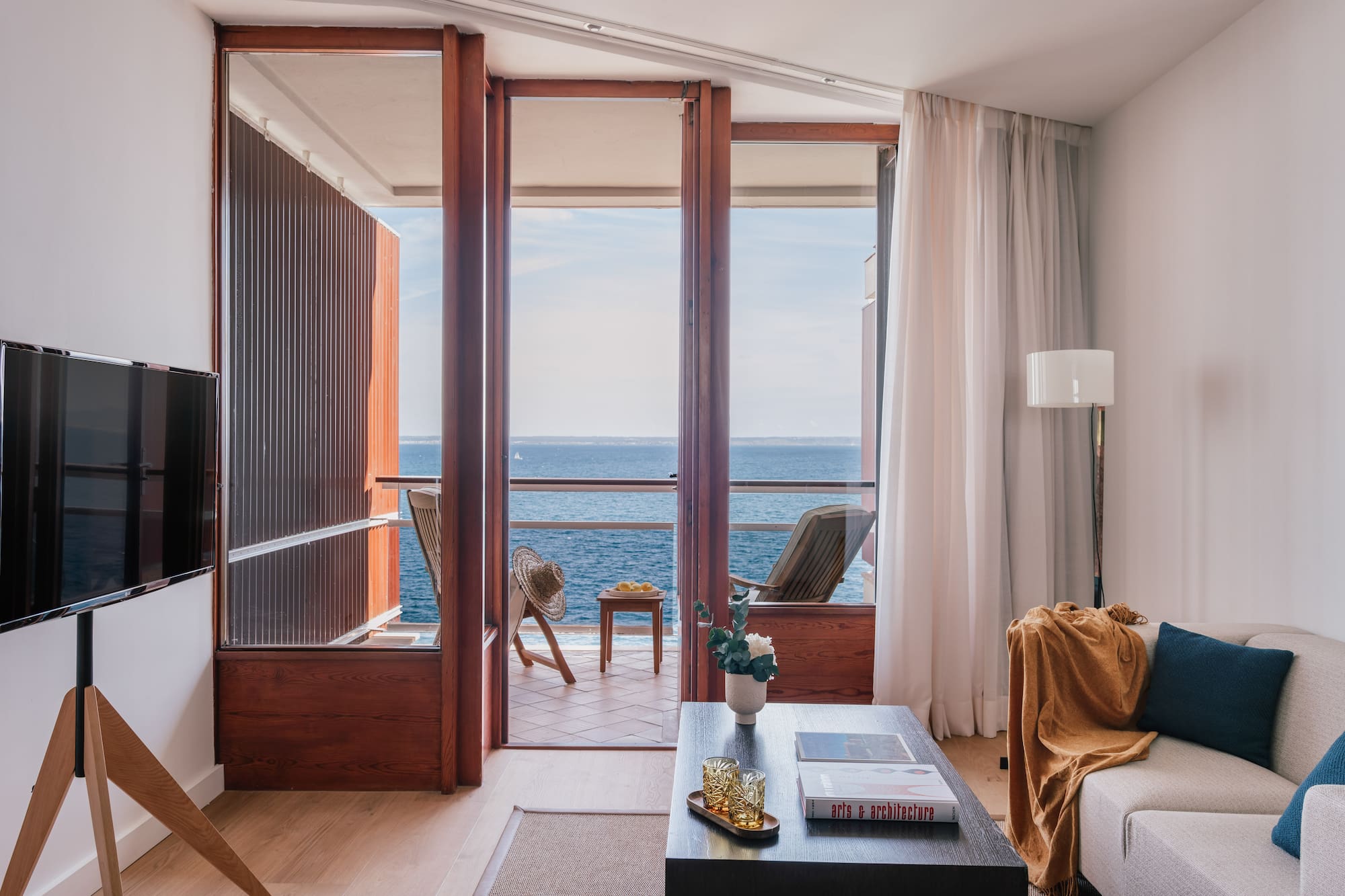 a living room with a view of the ocean