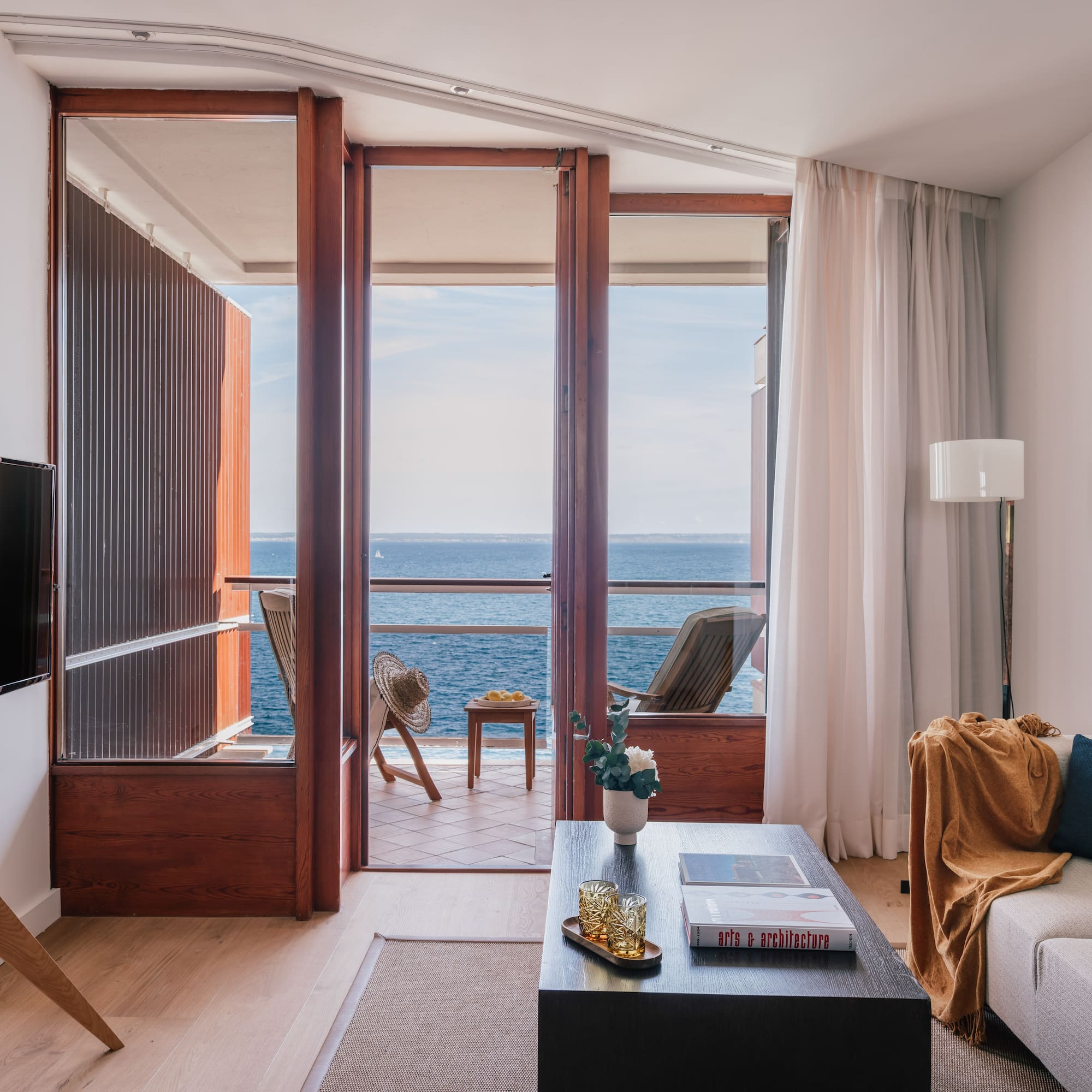 a living room with a view of the ocean