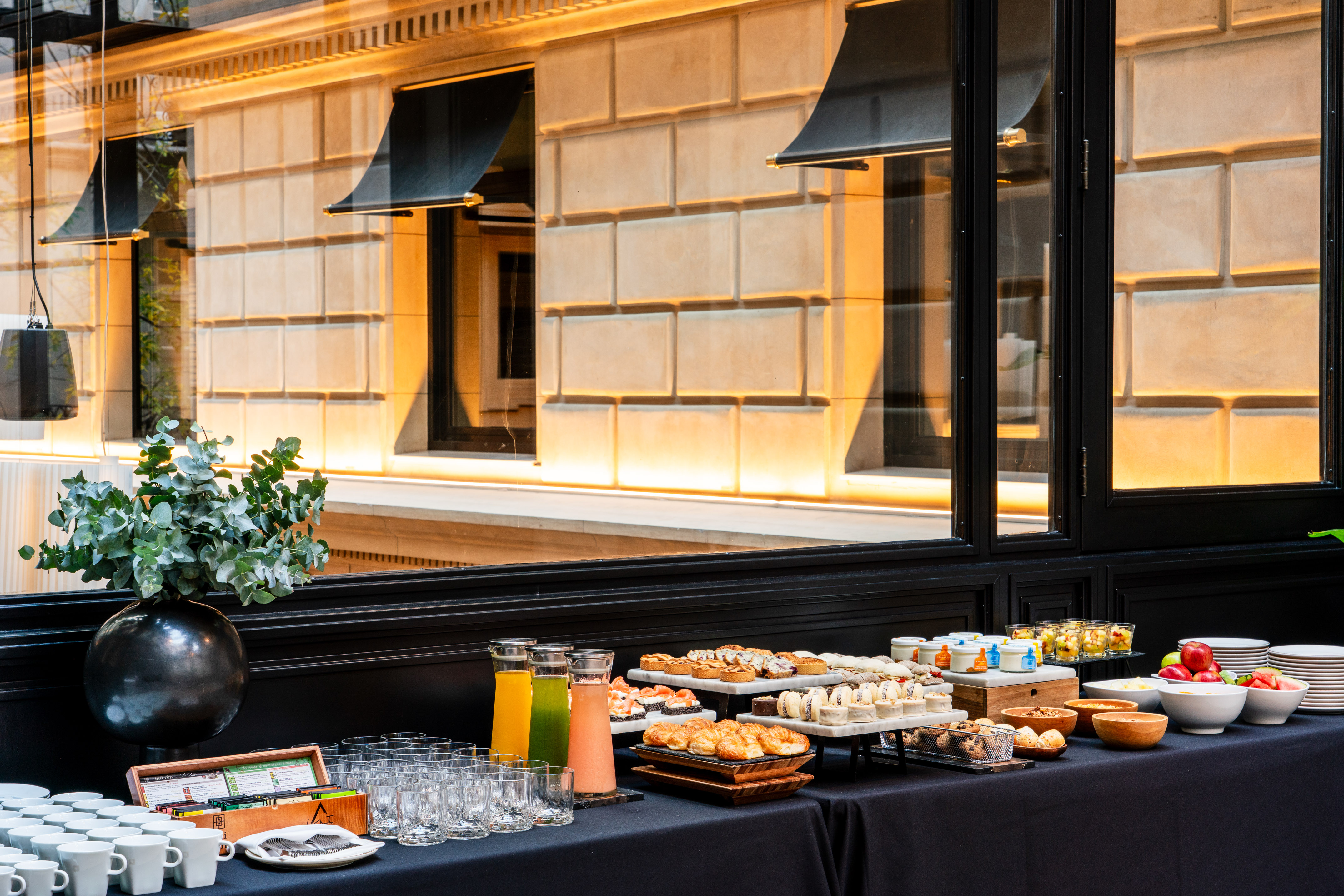 Elegant breakfast buffet with pastries, juices, fruit. Modern hotel catering.