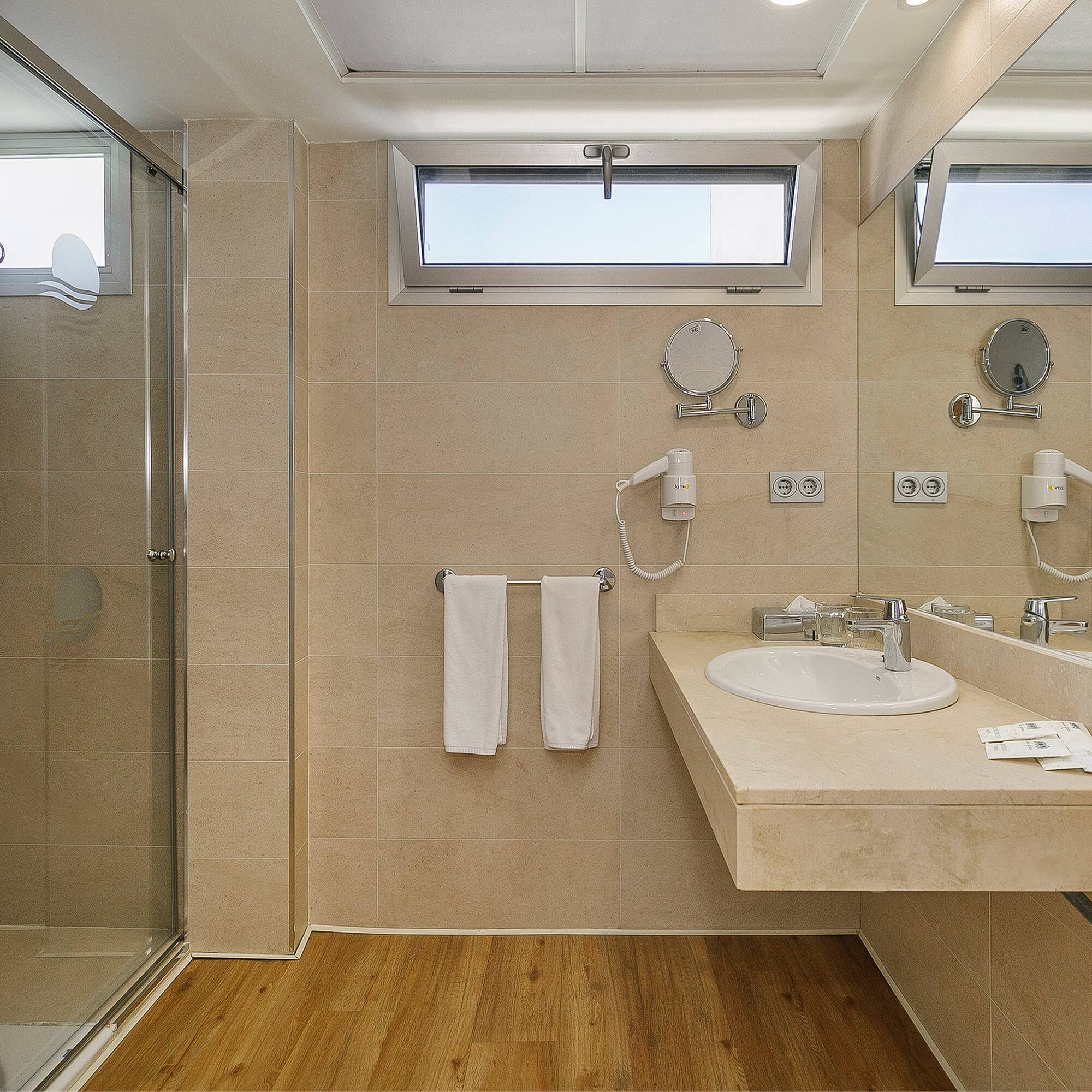 a bathroom with a shower and sink