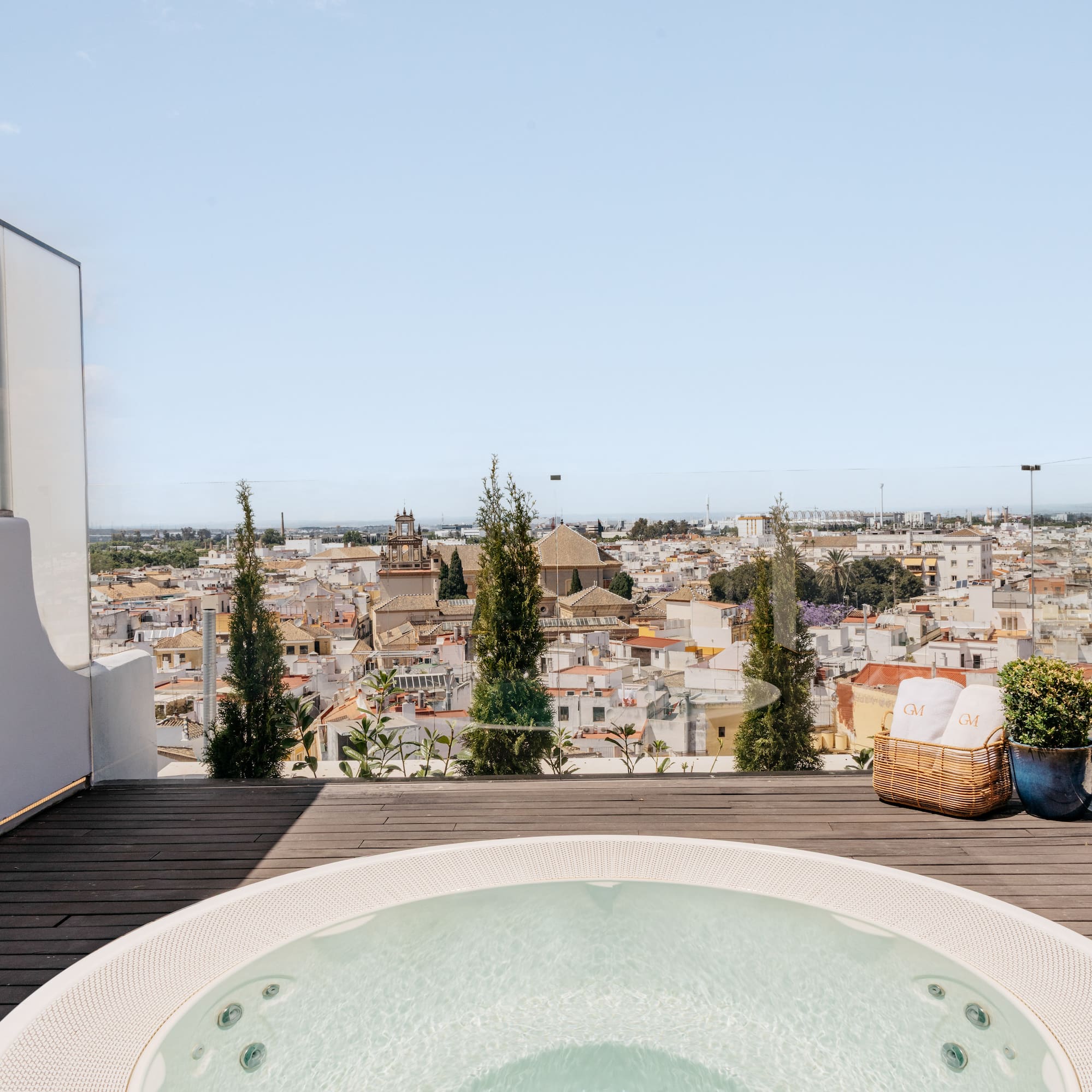 a hot tub on a deck overlooking a city