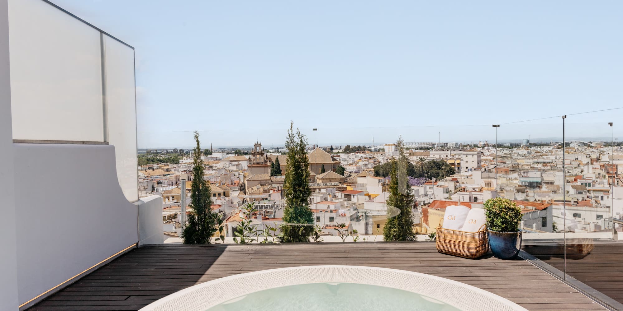 a hot tub on a deck overlooking a city