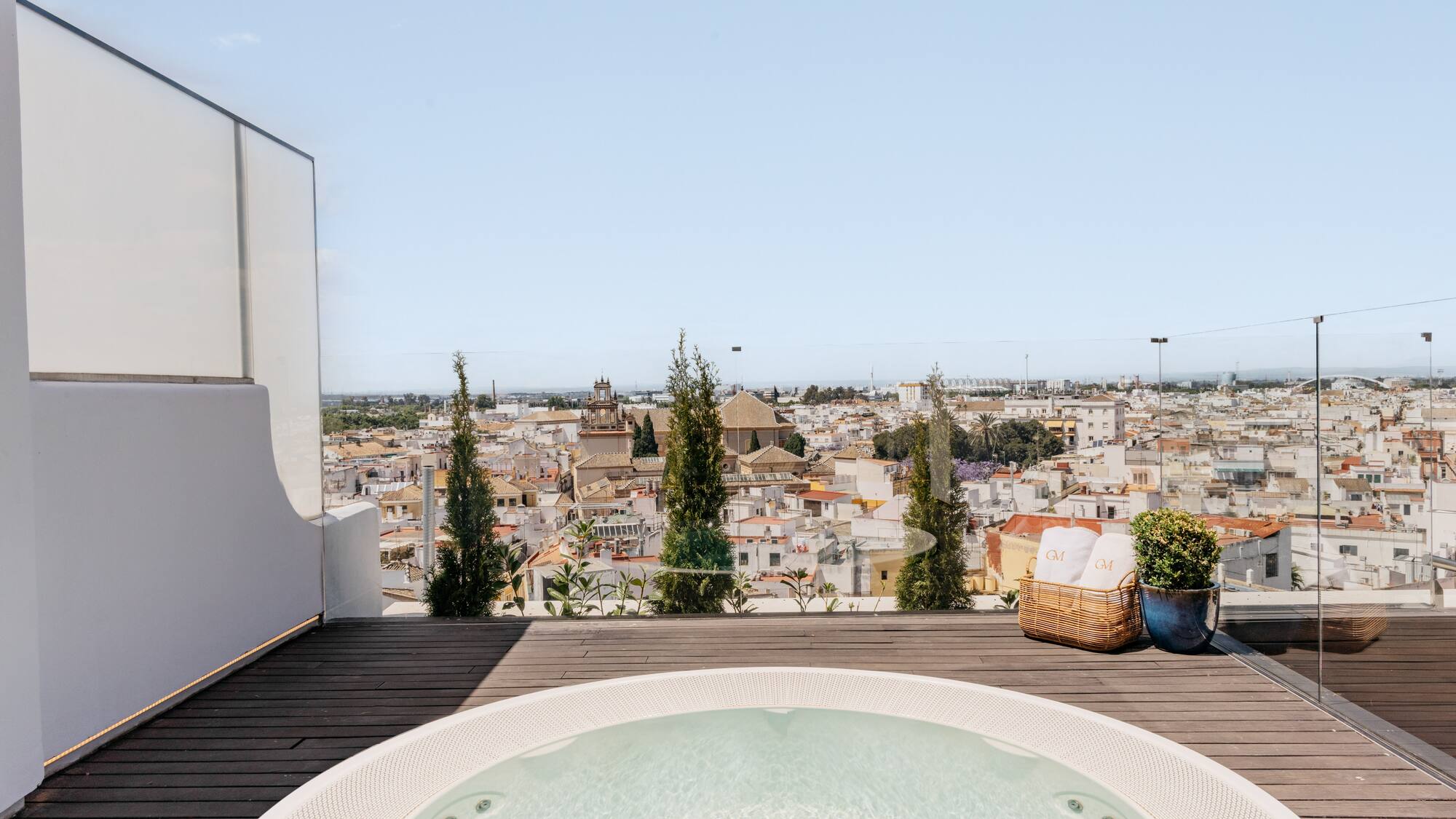 a hot tub on a deck overlooking a city