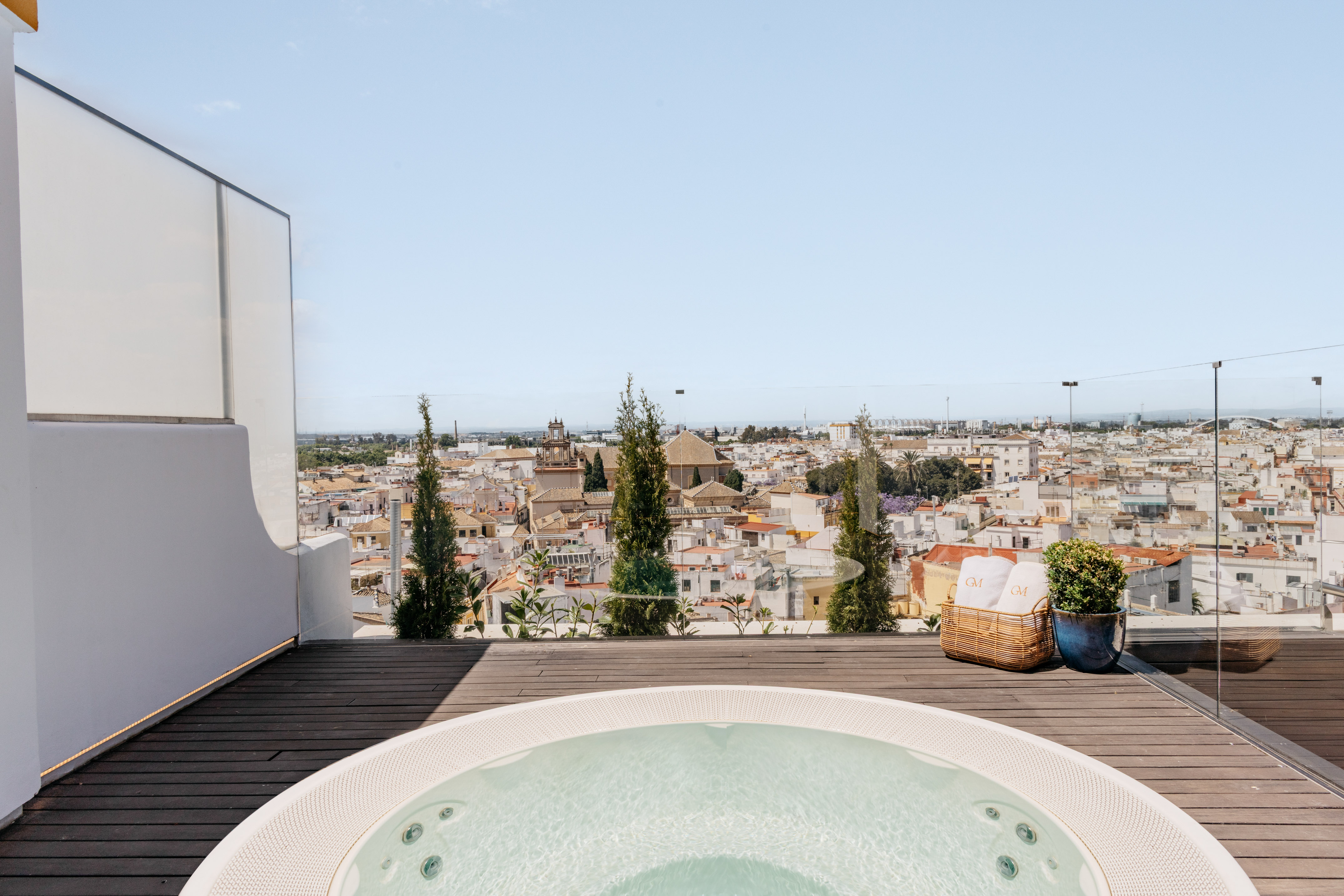 a hot tub on a deck overlooking a city