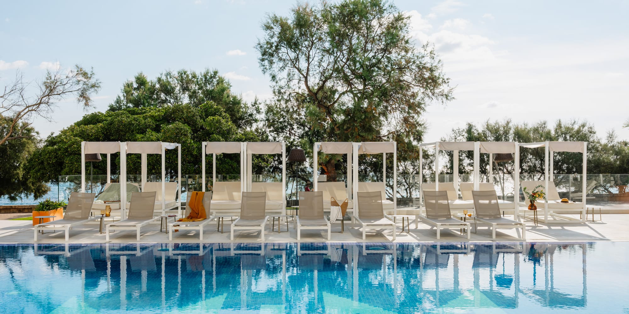 a pool with lounge chairs and a canopy