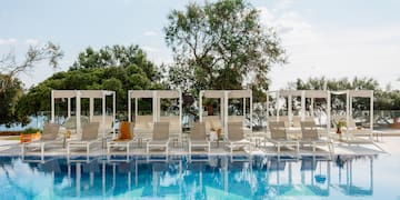a pool with lounge chairs and a canopy