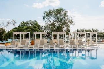 a pool with lounge chairs and a canopy