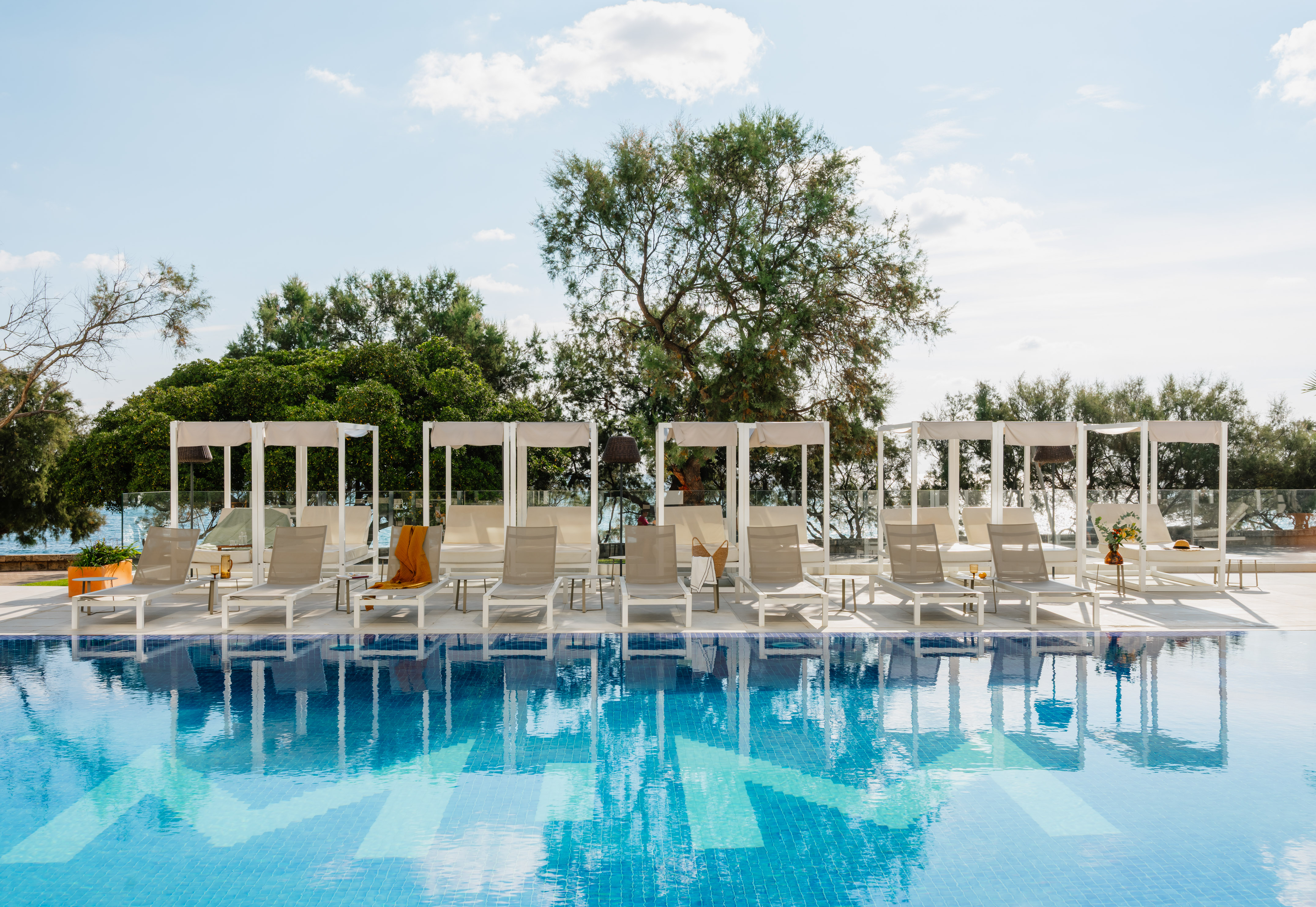 a pool with lounge chairs and a canopy