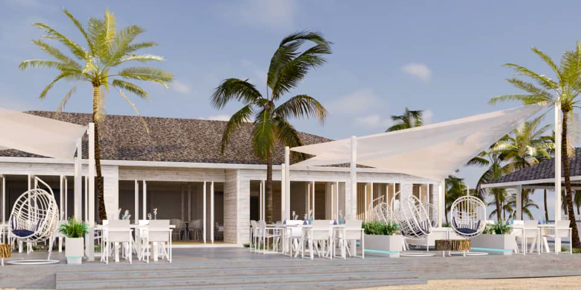 a building with palm trees and a white tent