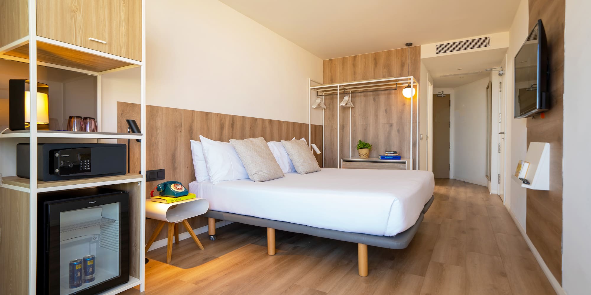 a room with a bed and a wood floor