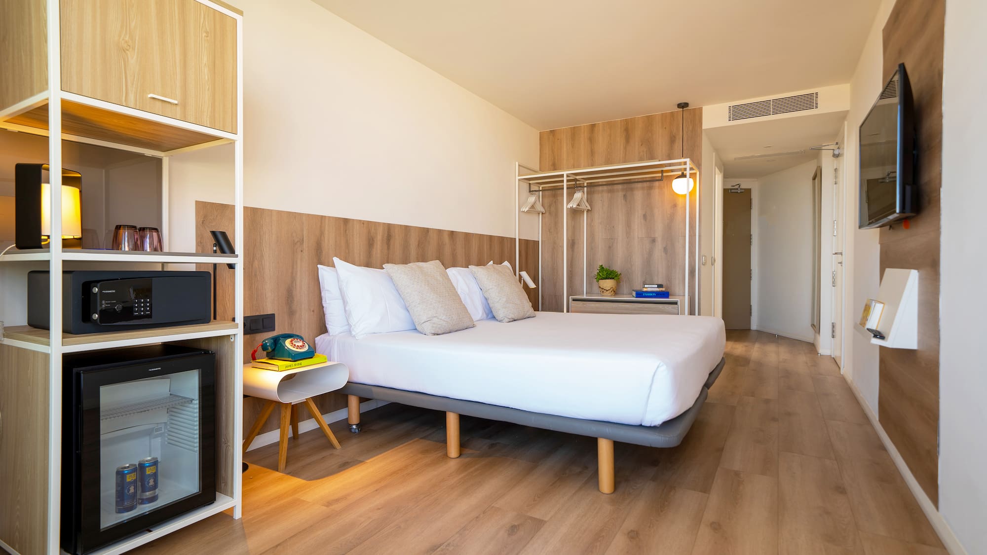 a room with a bed and a wood floor