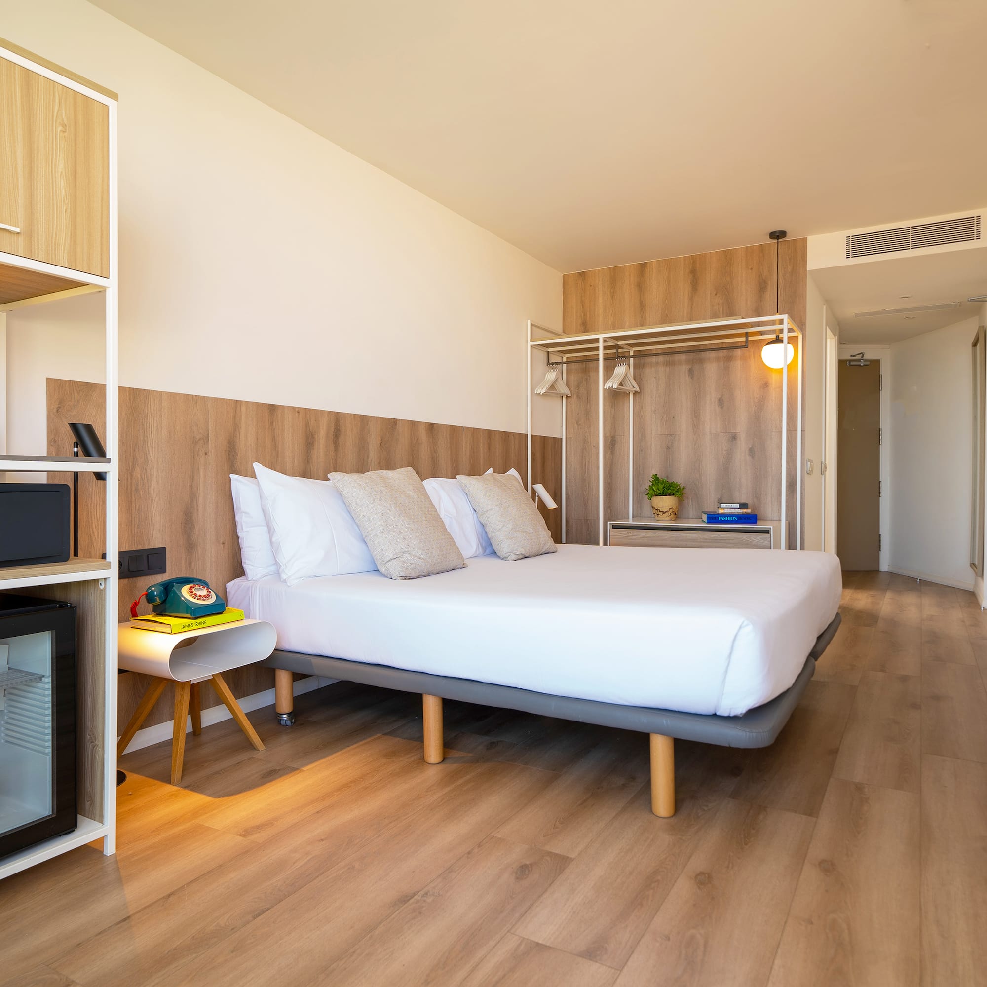 a room with a bed and a wood floor