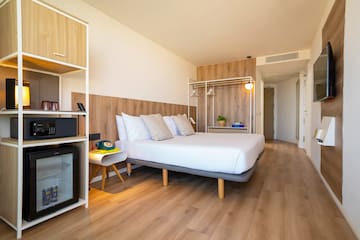 a room with a bed and a wood floor