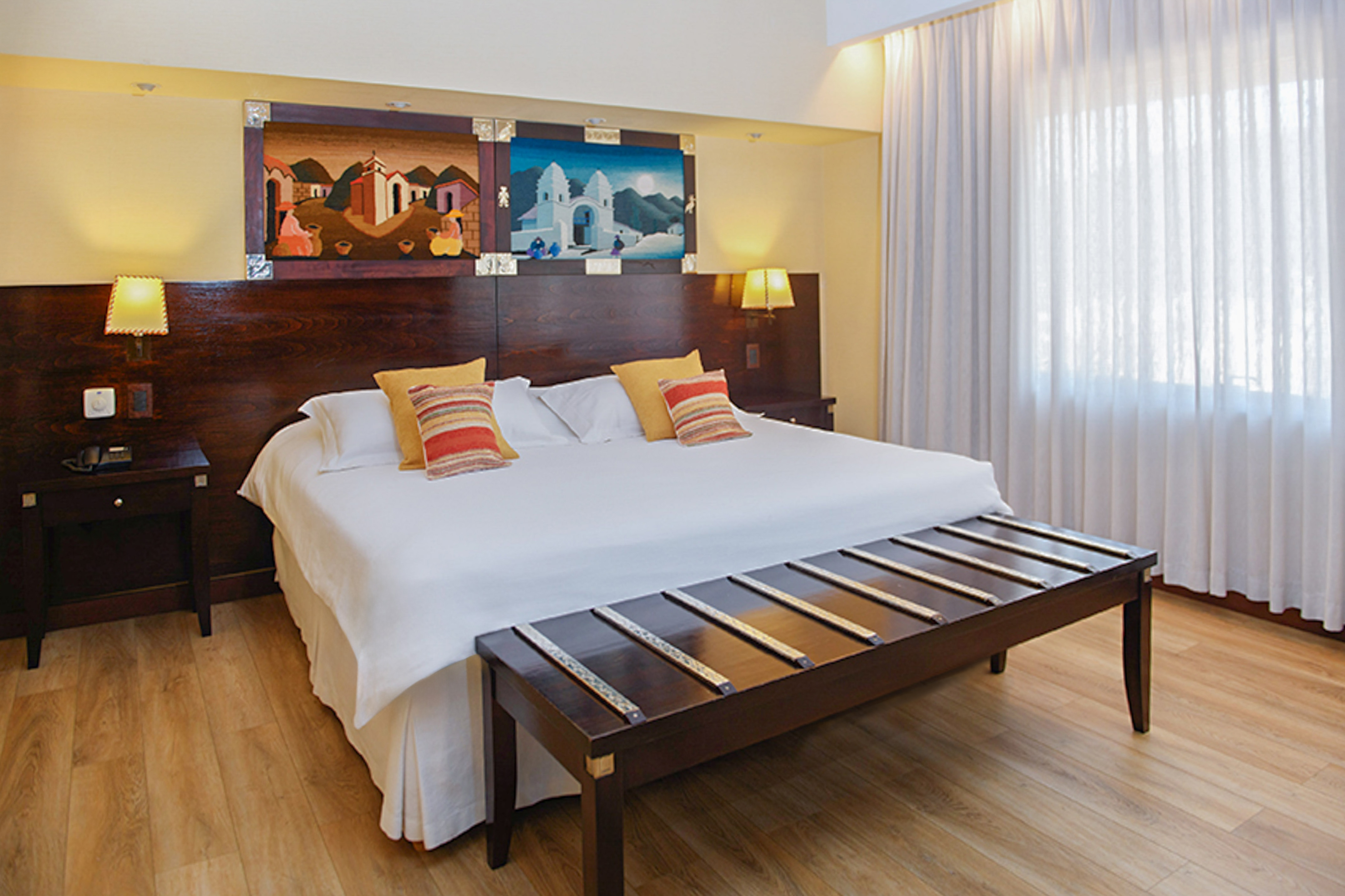 a bed with pillows and a table in a room